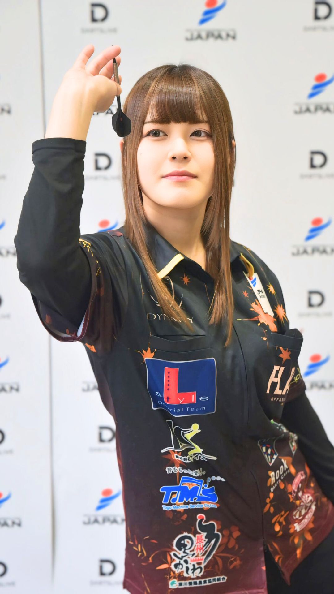 大会ユニフォーム姿でダーツを構える女性プロダーツプレイヤー中谷祐里プロ。真剣な表情で試合に挑む瞬間